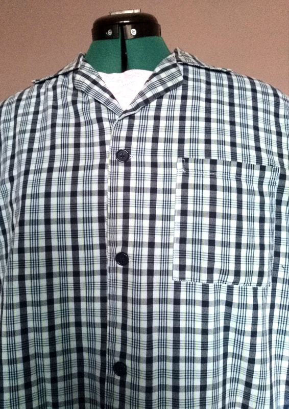 check shirt clothing protector with adjustable snaps at the back and thin towel lining