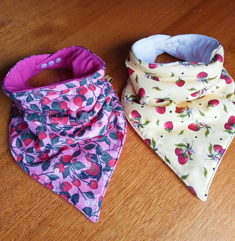 Pretty and fun banana bibs. These are waterproof with adjustable snaps.